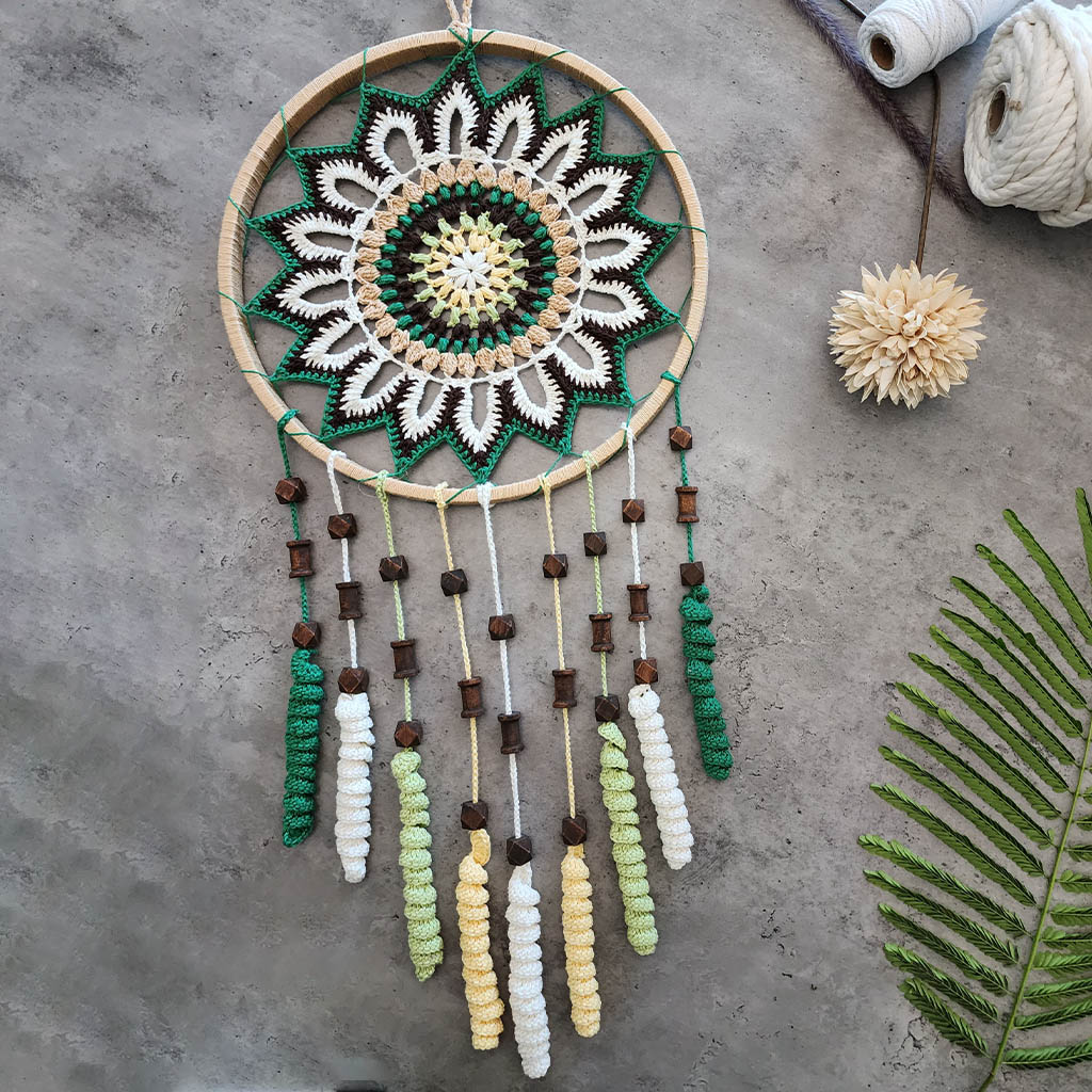 “Enchanting Greens Dreamcatcher” by ArtixHub – macramé dreamcatcher in moss, sage, and mint hues with wooden beads and curly tassels, evoking woodland tranquility. Ideal for bedrooms, reading corners, or boho-chic spaces, weaving nature’s calm into UAE interiors.