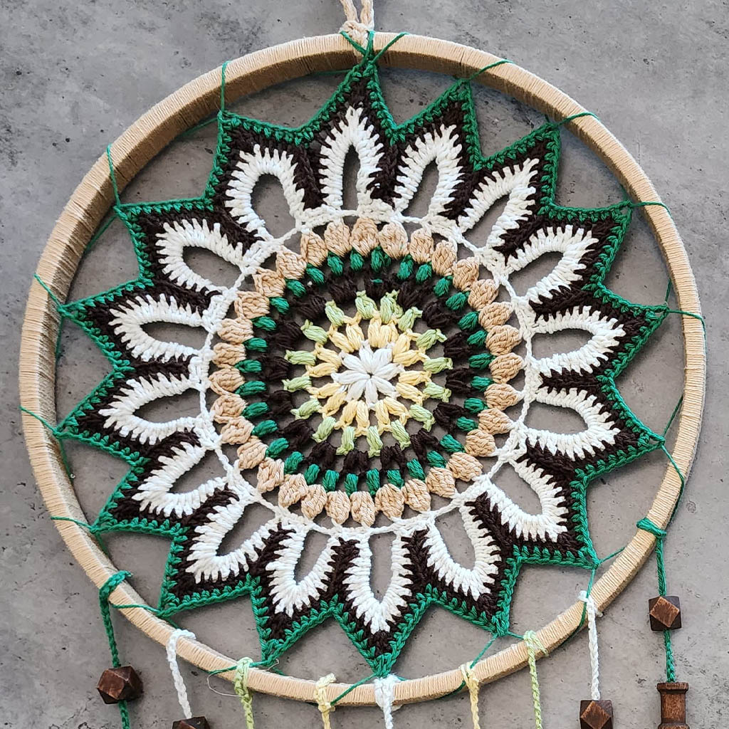 “Enchanting Greens Dreamcatcher” by ArtixHub – macramé dreamcatcher in moss, sage, and mint hues with wooden beads and curly tassels, evoking woodland tranquility. Ideal for bedrooms, reading corners, or boho-chic spaces, weaving nature’s calm into UAE interiors.