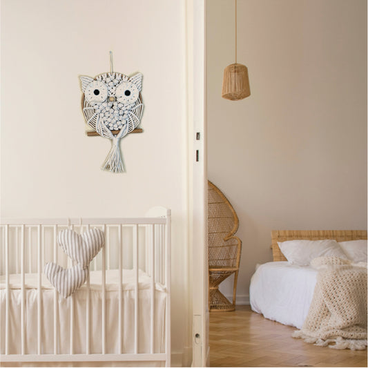 “Wise Guardian” by ArtixHub – natural-tone macramé owl perched on a wooden dowel, featuring textured bobbles and fringe that evoke nocturnal wisdom. Ideal for home offices, libraries, or bohemian living rooms, adding a touch of woodland magic to UAE décor.