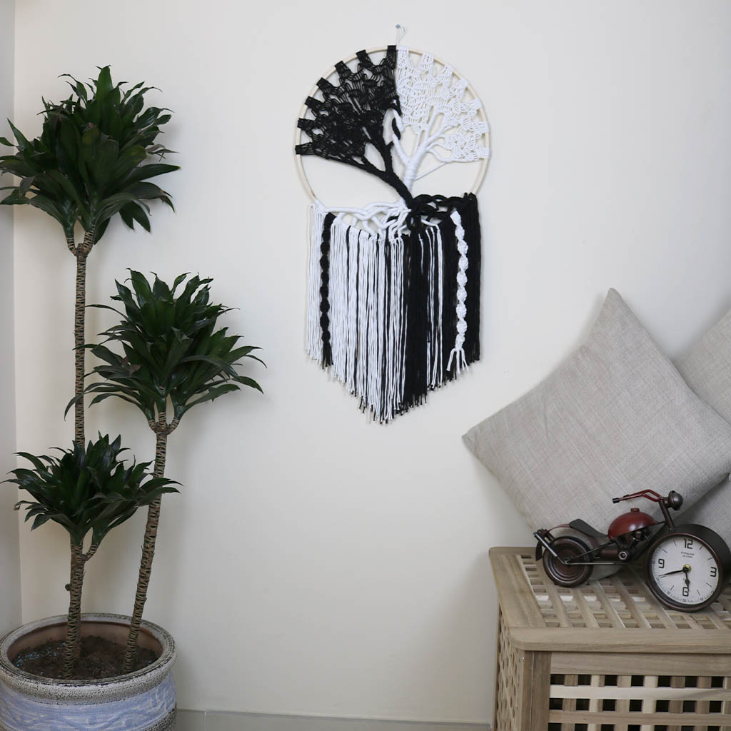 “Yin Yang Tree” by ArtixHub – black & white macramé tree wall hanging with contrasting strands and fringe, embodying balance and harmony. Ideal for meditation rooms, home offices, or contemporary living areas, enhancing UAE spaces with modern bohemian flair.