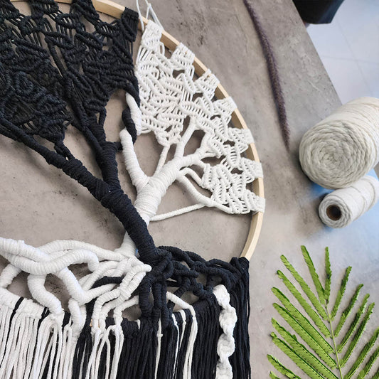 “Yin Yang Tree” by ArtixHub – black & white macramé tree wall hanging with contrasting strands and fringe, embodying balance and harmony. Ideal for meditation rooms, home offices, or contemporary living areas, enhancing UAE spaces with modern bohemian flair.