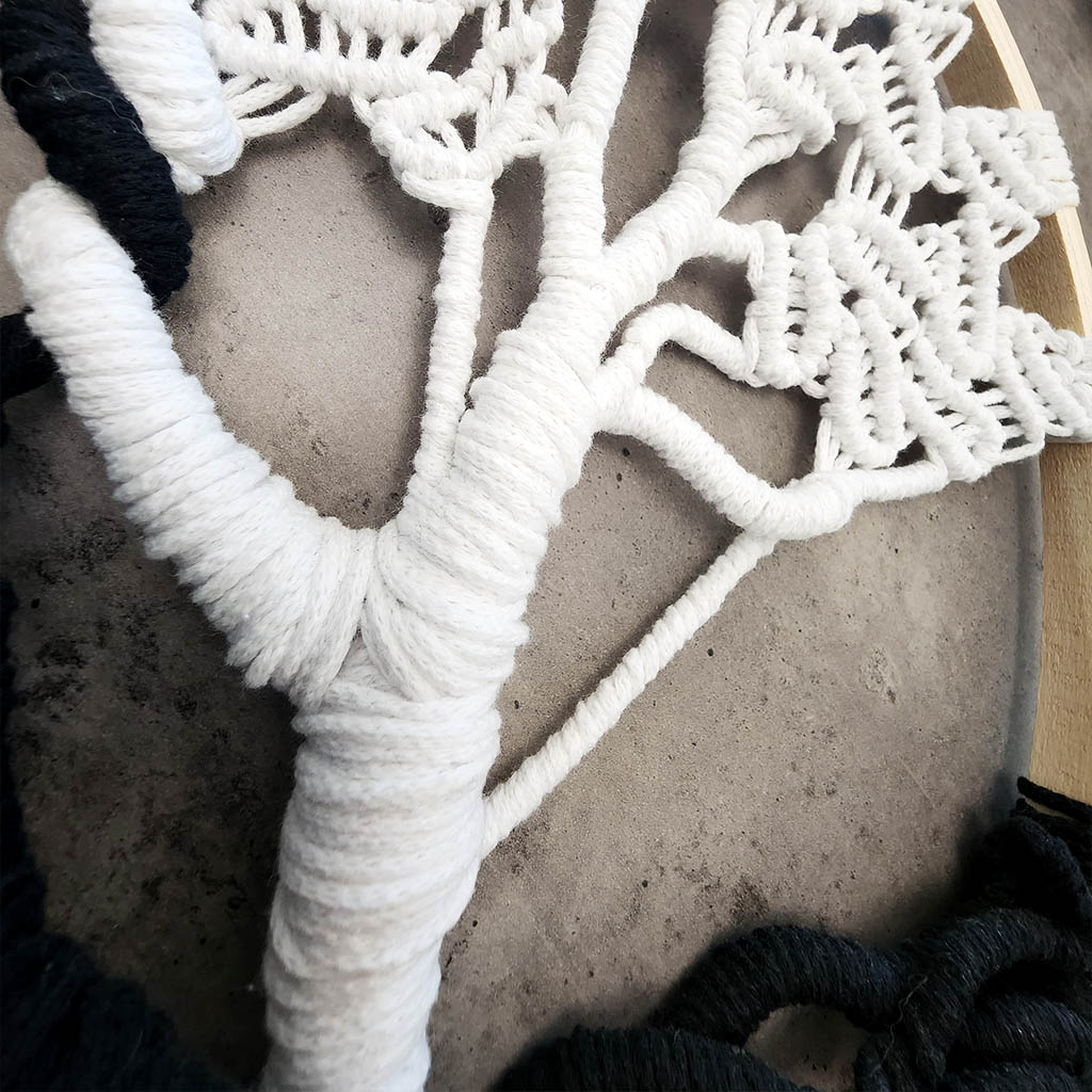 “Yin Yang Tree” by ArtixHub – black & white macramé tree wall hanging with contrasting strands and fringe, embodying balance and harmony. Ideal for meditation rooms, home offices, or contemporary living areas, enhancing UAE spaces with modern bohemian flair.