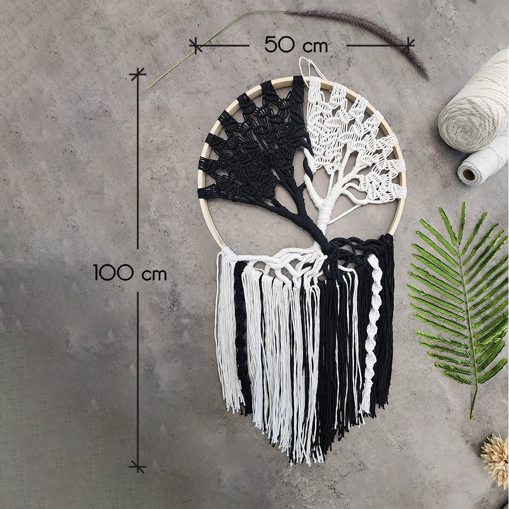 “Yin Yang Tree” by ArtixHub – black & white macramé tree wall hanging with contrasting strands and fringe, embodying balance and harmony. Ideal for meditation rooms, home offices, or contemporary living areas, enhancing UAE spaces with modern bohemian flair.