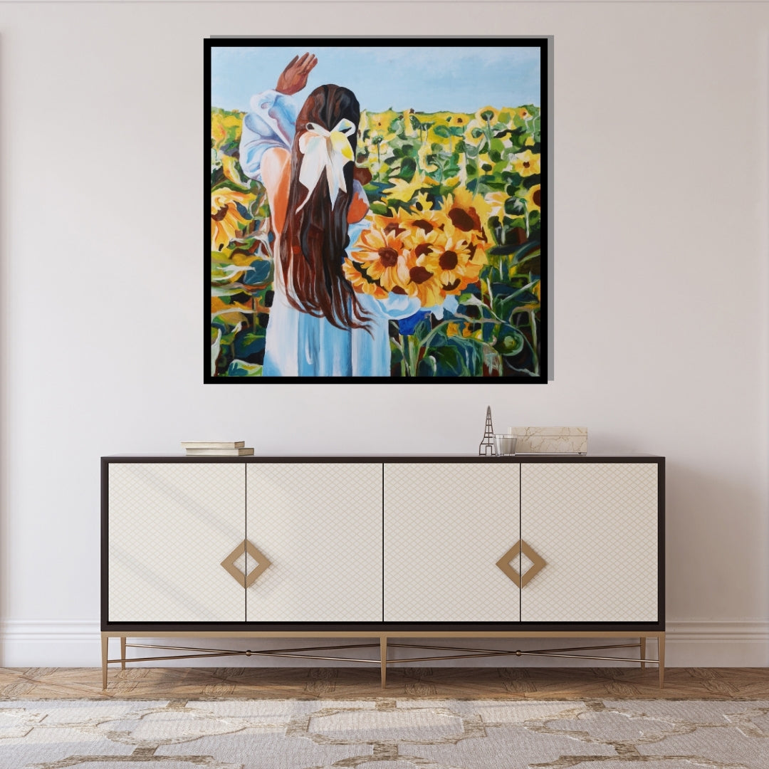 Painting of a woman in a blue dress with a white bow standing in a sunflower field. Painting of a girl with long brown hair tied with a white ribbon, holding a bouquet of sunflowers while standing in a sunflower field by Mira Ayyash