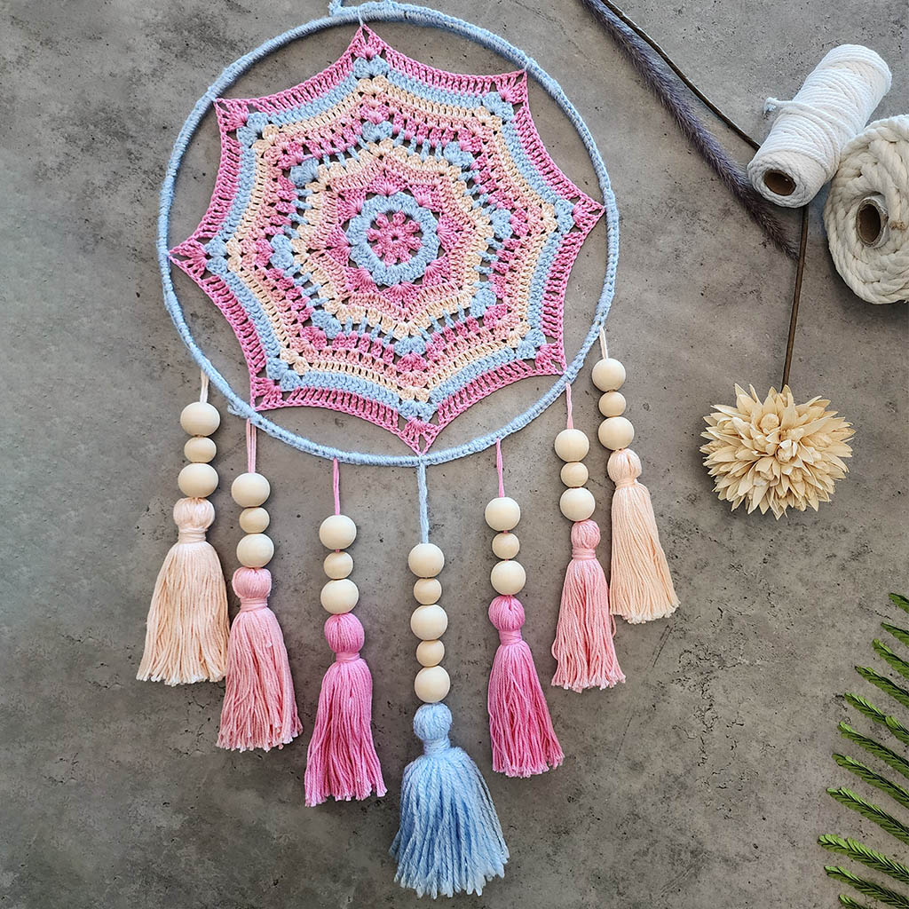 "Dreamscape" by ArtixHub – macramé wall hanging with pastel pink and blue tassels accented by natural wood beads, creating a playful cascade of color and texture. Ideal for nurseries, playrooms, or boho-inspired living spaces, adding whimsical charm to UAE interiors.