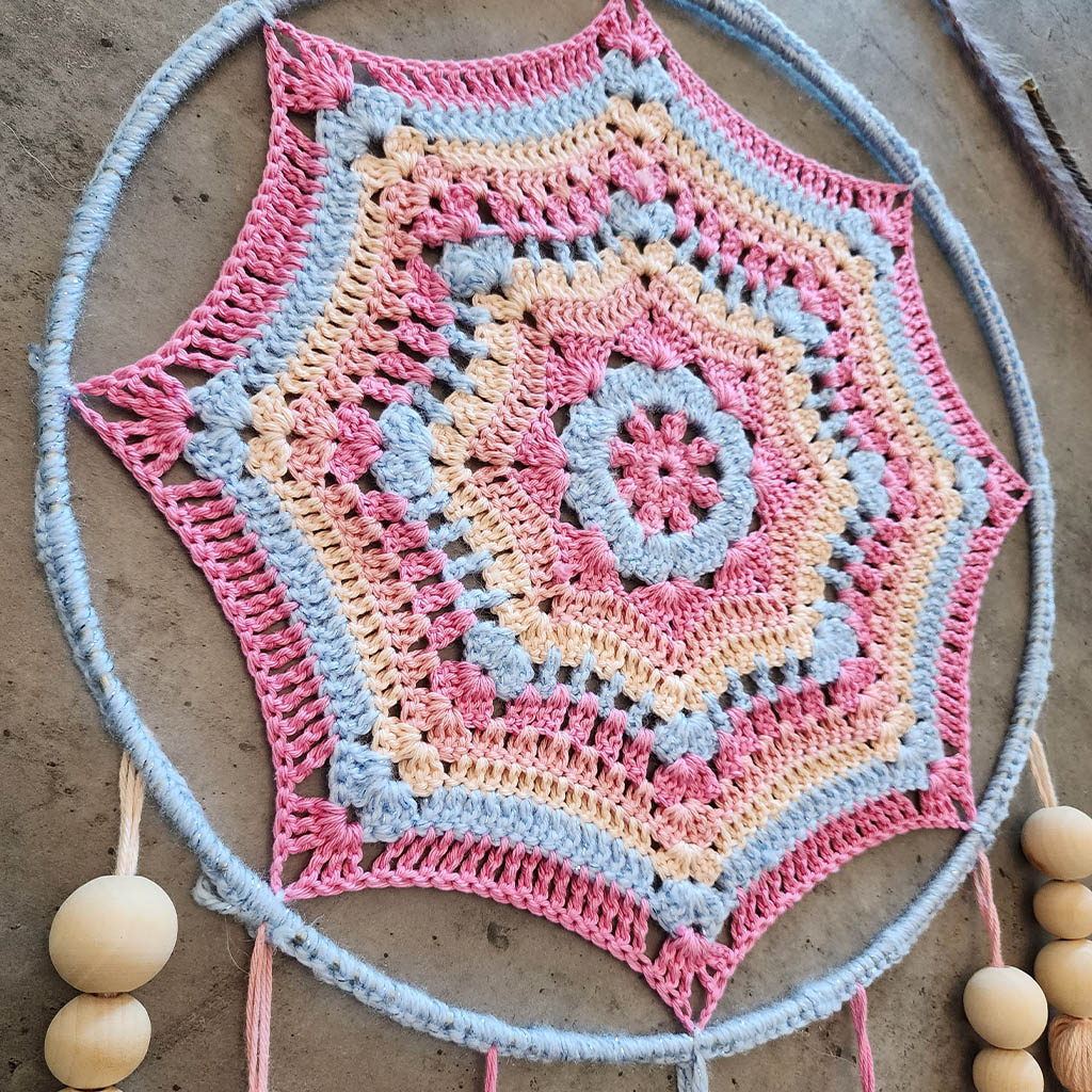 "Dreamscape" by ArtixHub – macramé wall hanging with pastel pink and blue tassels accented by natural wood beads, creating a playful cascade of color and texture. Ideal for nurseries, playrooms, or boho-inspired living spaces, adding whimsical charm to UAE interiors.