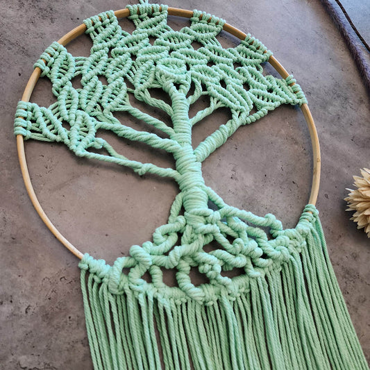 “Emerald Embrace” by ArtixHub – sage-green macramé tree wall hanging with cascading fringe on a wooden hoop, symbolizing growth and grounding. Ideal for entryways, home offices, or eco-conscious living rooms, bringing nature-inspired serenity to UAE homes.