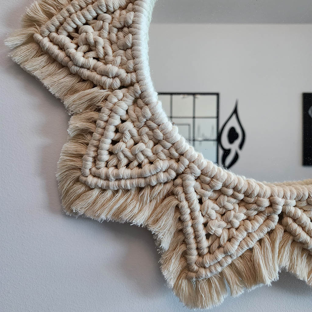 “Halo Mirror” by ArtixHub – handcrafted macramé sunburst mirror with cotton fringe radiating around a central glass, reflecting light and texture. Ideal for entryways, bathrooms, or living rooms, adding boho-chic illumination to UAE homes.