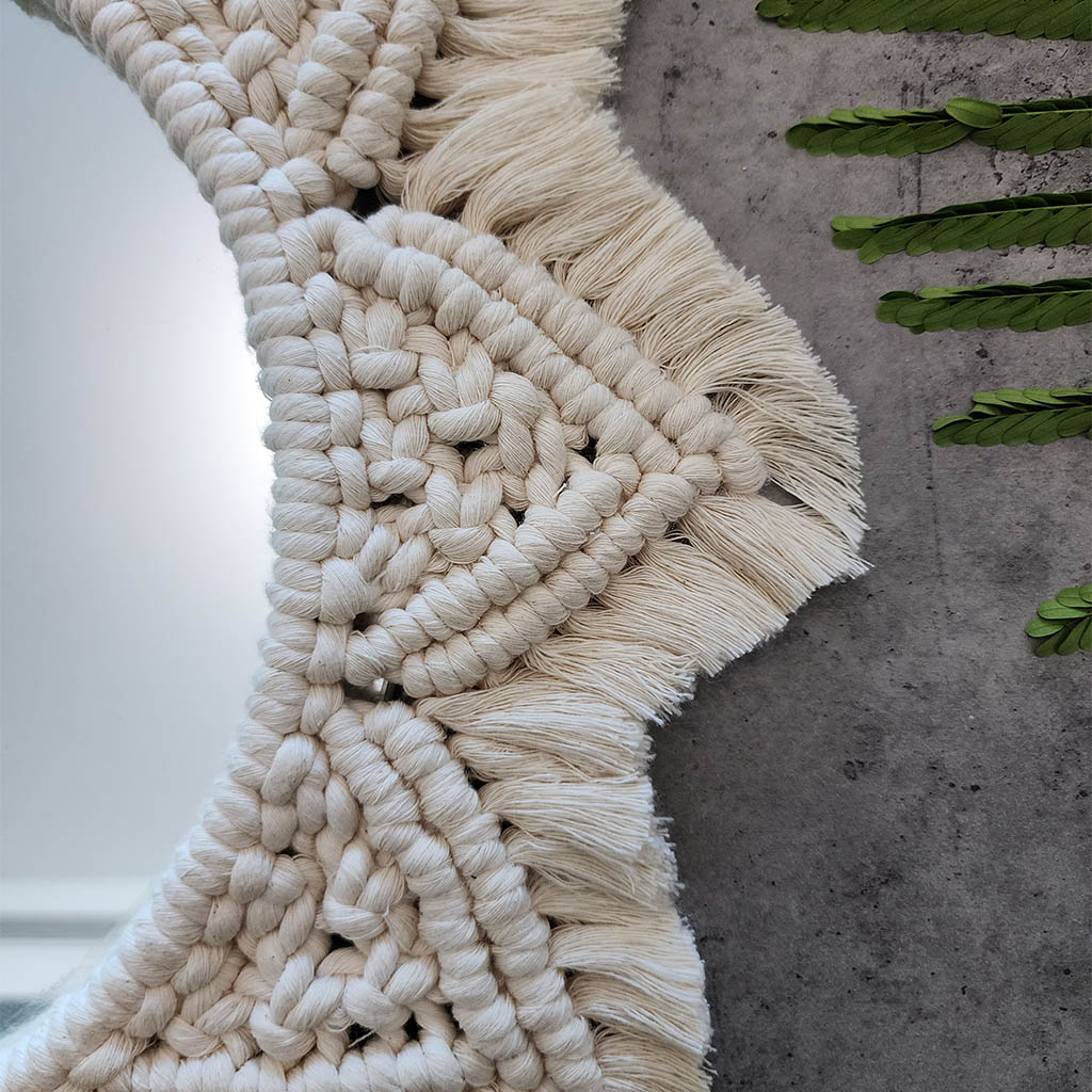 “Halo Mirror” by ArtixHub – handcrafted macramé sunburst mirror with cotton fringe radiating around a central glass, reflecting light and texture. Ideal for entryways, bathrooms, or living rooms, adding boho-chic illumination to UAE homes.